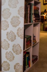 Use stencils to revamp a bland piece of furniture in your home, like I did for my craft shelf!