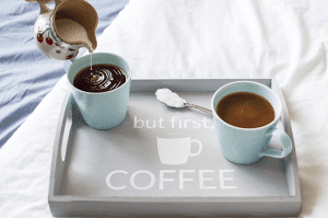 Make mornings more fun with an easy-to-make tray for your daily cup of coffee. Using chalk paint, a silhouette stencil, and an unfinished wooden tray from any craft store!