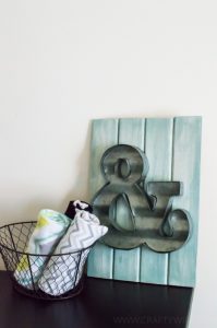 Create an easy art display with a metal ampersand and wooden board from Michaels Arts & Craft store. Perfect decor for a nursery or a gallery wall!