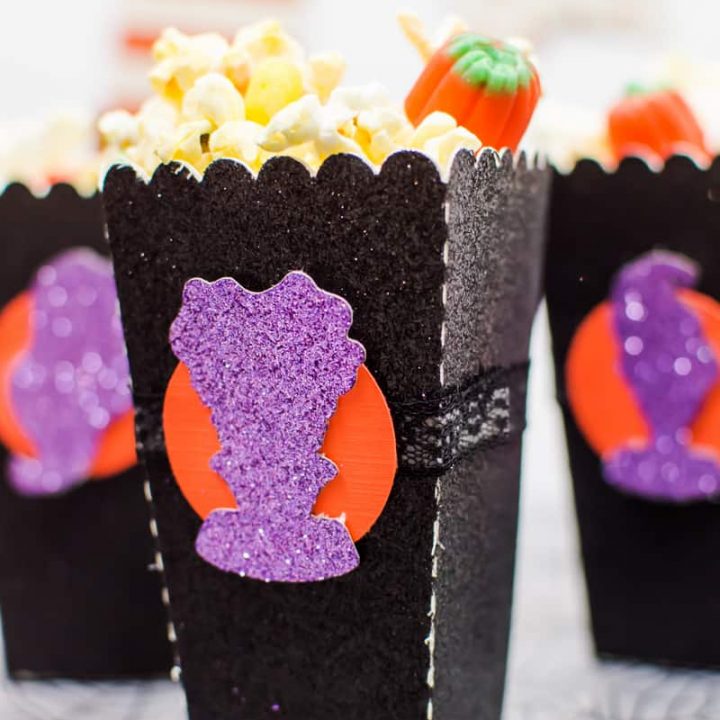 Halloween Popcorn Bags - Hocus Pocus is my favorite Halloween movie and I watch it multiple times every year. These DIY paper popcorn bags cut with my Silhouette machine are the perfect movie-watching treat bag!