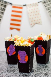 Halloween Popcorn Bags - Hocus Pocus is my favorite Halloween movie and I watch it multiple times every year. These DIY paper popcorn bags cut with my Silhouette machine are the perfect movie-watching treat bag!
