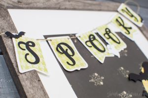 Spooky Halloween Frame - I hate the scary aspect of Halloween so I typically don't decorate for the holiday. But I found the perfect non-scary Silhouette file and paired it with my paper banner to create a fun Halloween decoration that's more cute than spooky!