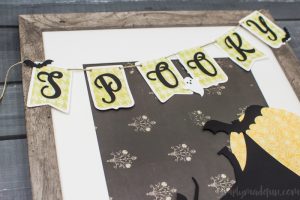 Spooky Halloween Frame - I hate the scary aspect of Halloween so I typically don't decorate for the holiday. But I found the perfect non-scary Silhouette file and paired it with my paper banner to create a fun Halloween decoration that's more cute than spooky!