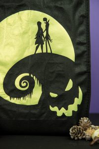Halloween Tote Bag - As a kid I always wanted my own personalized Halloween tote bag to carry my candy around in, but since that'll never happen I can at least do it for my kids! This easy Nightmare Before Halloween tote bag can be made with a Silhouette or Cricut machine. It's so spooky, even the parents will want one of their own.