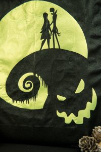 Halloween Tote Bag - As a kid I always wanted my own personalized Halloween tote bag to carry my candy around in, but since that'll never happen I can at least do it for my kids! This easy Nightmare Before Halloween tote bag can be made with a Silhouette or Cricut machine. It's so spooky, even the parents will want one of their own.