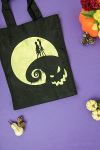 Halloween Tote Bag - As a kid I always wanted my own personalized Halloween tote bag to carry my candy around in, but since that'll never happen I can at least do it for my kids! This easy Nightmare Before Halloween tote bag can be made with a Silhouette or Cricut machine. It's so spooky, even the parents will want one of their own.