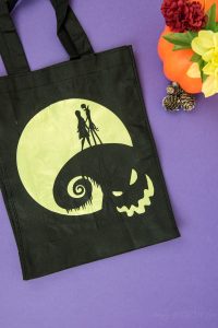Halloween Tote Bag - As a kid I always wanted my own personalized Halloween tote bag to carry my candy around in, but since that'll never happen I can at least do it for my kids! This easy Nightmare Before Halloween tote bag can be made with a Silhouette or Cricut machine. It's so spooky, even the parents will want one of their own.
