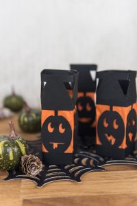 Paper Pumpkin Lanterns - I love lanterns but I hate spending money on them at the store so I decided to make my own mini Halloween paper lanterns instead. They're an easy DIY, cheap, and family friendly. And can be made with a Silhouette or Cricut machine!