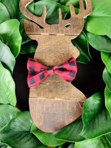 Make the easiest holiday wreath to last through Christmas and beyond! All it takes is a little bit of greenery, wood, and the perfect buffalo plaid ribbon to give your front door a little holiday style.