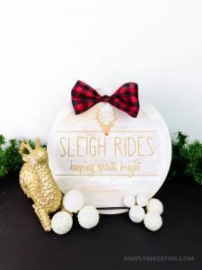 Rae Dunn Inspired Wooden Holiday Sign - After the Christmas decor comes down the whole house feels empty. Make some wall art that'll last all winter long with your Silhouette Machine and some stencil vinyl. This Rae Dunn holiday sign is the perfect rustic DIY for your home!