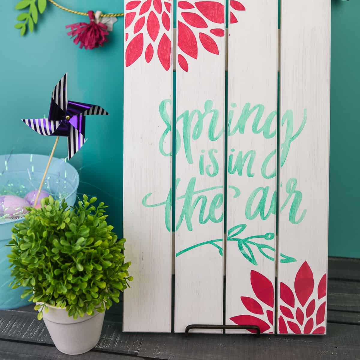 Painted Wooden Spring Sign - Dress up your front porch or your mantle this spring with a bright and colorful wooden sign! Use your Silhouette Cameo to cut out a stencil and pick your favorite paint colors to make this sign your own. It's fun, easy, and you can do it in 20 minutes (or less!).