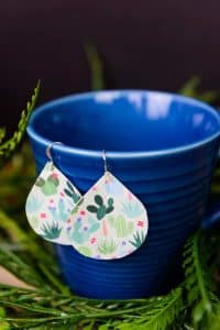 Printed Heat Transfer Vinyl Earrings - It's official, you can use Heat Transfer Vinyl on anything! If you love faux leather earrings because they're lightweight and easy to DIY but are tired of them being plain, you can easily dress them up with heat transfer vinyl and an iron! They take less than 20 minutes to make and the pattern choices are endless.