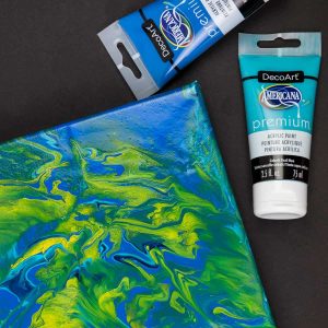 Acrylic Pour Canvas - This is one messy DIY but it is really fun to make too! You can get creative with color and design and no two art projects will be the same! It's the perfect art piece for your home that YOU made all on your own!