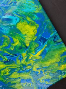 Acrylic Pour Canvas - This is one messy DIY but it is really fun to make too! You can get creative with color and design and no two art projects will be the same! It's the perfect art piece for your home that YOU made all on your own!